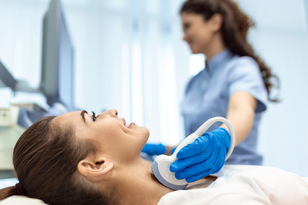 Female patient receives thyroid diagnostics.
